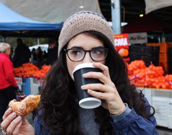instagrammer inexplicablewanderlust with a coffee and pastry at the Capital Region Farmers Market, Canberra